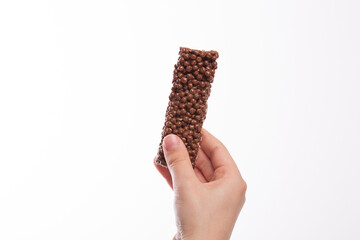 Boy hand holding a chocolate cereal bar