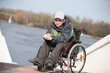 © Светлана Лазаренко - A man wearing sunglasses in a wheelchair for a walk