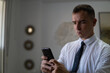 © Sergio Cano - Young businessman reads a text message.