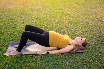 Poster - Young caucasian blonde female practicing yoga in the park