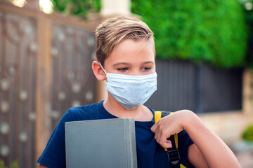 Wall Mural - Pupil with face mask staying outdoor. Back to school.