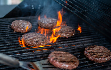 Hamburger on Grill being Flipped