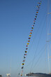 Mast of a big sailboat with flags hanging on it