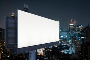 Blank white road billboard with Bangkok cityscape background at night time. Street advertising poster, mock up, 3D rendering. Side view. The concept of marketing communication to sell idea.