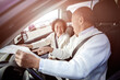 © Take A Pix Media/Stocksy - Happy traveling senior Asian couple looking at a map inside a car