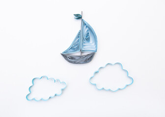 Sailboat in the clouds Isolated on white background. Hand made of paper quilling technique.