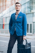 Modern Businessman Dressed In Blue Jacket On The Background Of The Business Center