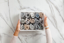 Woman Hands Placing Organizer Drawer Divider With Full Of Folded Underwears And Socks.