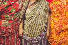 Three Woman Dressed In Saris