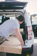 © Gillian Vann/Stocksy - man loading boxes into back of car