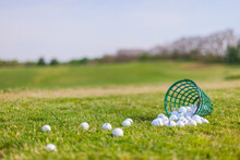 Spilled Bucket Of Golf Balls On Empty Driving Range