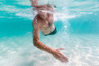 © Jovana Milanko/Stocksy - Man swimming in the sea towards the camera