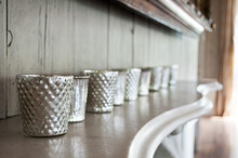 A Line Of Elegant Silver Cups On A Marble Mantle