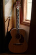 © Brian Powell/Stocksy - dusty guitar in the corner