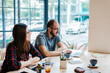 © Aleksandra Jankovic/Stocksy - Co-workers working together on laptop