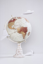 World Globe With Paper Planes Flying Around