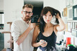 © Ania Boniecka/Stocksy - Young couple taking a self portrait in the mirror