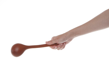 a hand holding a wooden ladle upside down.