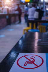 The new normal of people in modern society, a sign prohibiting sitting in a restaurant to prevent safety from communicable diseases. Covid-19, social distancing, a safe distance of 2 meters.