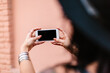 © Kristen Curette Photography LLC/Stocksy - A woman on a mobile phone taking a selfie