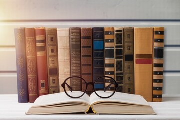 Wall Mural - A stack of books with glasses for reading on the desk