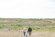 © Carey Shaw/Stocksy - Young family walking together.