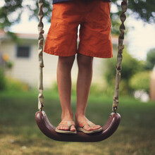 Boy On A Backyard Swing