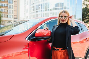 Wall Mural - Close Up Portrait of One Stylish Young Female Posing Near the Car