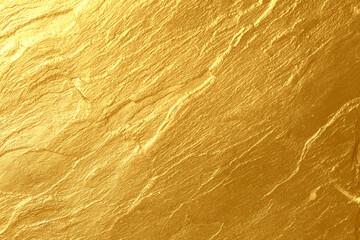 Details of golden texture background. Gold color painted on cement wall for background and wallpaper. Metal texture background in gold. Shiny yellow leaf gold foil texture background. Gold paint.