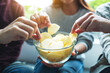 © Farknot Architect - Closeup image of friends sharing and eating potato chips at home party together