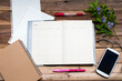 © phenphayom - notebook planner ,writing paper and mobile phone for business work arrangement flat lay style on background wooden