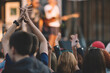© Alexey Klementiev/Stocksy - hands of crowd on the music show , selective focus ,some blur