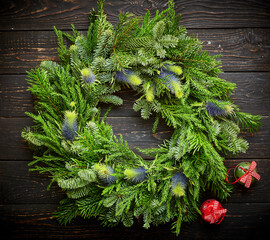 Wall Mural - Christmas wreath on dark wooden background