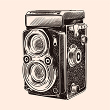 Old Vintage Camera With Two Lenses Isolated On A Beige Background.