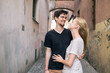© Tomas Mikula/Stocksy - Young couple in the tiny street in the city