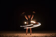 © Mosuno/Stocksy - Woman Spinning With Fire