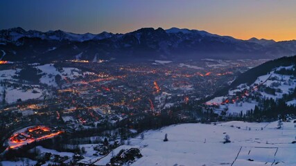Wall Mural - Dusk over zakopane city in winter, aerial view