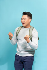 Wall Mural - Happy successful student, business man winning, fists pumped celebrating success isolated blue background.