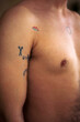 © VeaVea/Stocksy - Details of tattoos on a male body