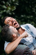 © Michela Ravasio/Stocksy - Happy gay couple having fun together