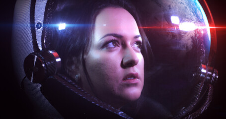 Wall Mural - portrait shot of the young beautiful female astronaut in space helmet. she is exploring outer space 
