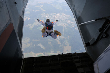 Poster - Skydiving. Start jump. A skydiver has just jumped out of a plane into the sky.