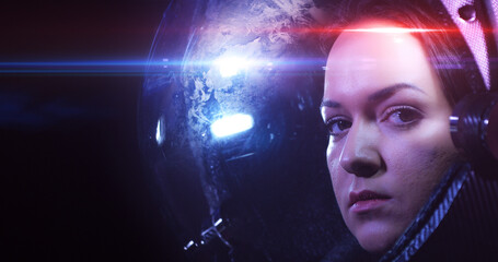 Wall Mural - young brave beautiful female astronaut in space helmet looking at camera. she is exploring outer spa