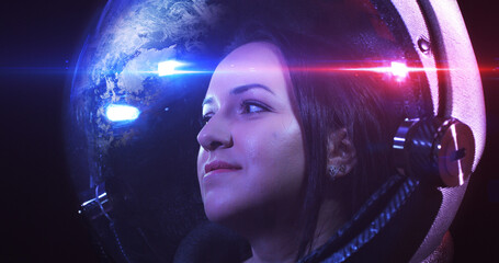 Wall Mural - young brave beautiful female astronaut in space helmet looking at camera. she is exploring outer spa