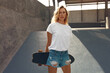 © puhhha - Skater Girl With Skateboard Portrait. Teenager In Casual Outfit Posing Against Concrete Ramp At Skatepark. Urban Subculture And Skateboarding As Lifestyle Of Active Teens In City.