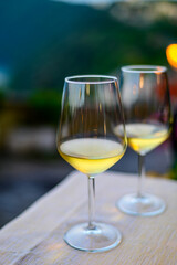 Two glasses of cold dry white wine served outdoor in cafe at night in Italy