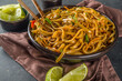 Asian vegetarian  pasta, Homemade udon noodles with stir fry  shiitake mushrooms, sesame and vegetables, soy sauce and lime, dark grey background copy space
