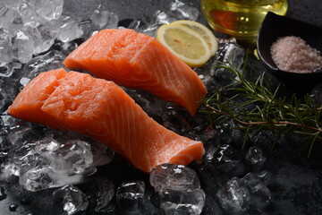 Raw salmon steaks on ice background 