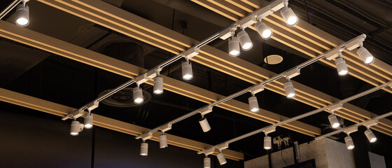 Spotlights set hanging on the ceiling. Track LED-lighting system