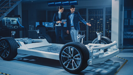 Poster - Female Chief Engineer Uses Tablet Computer, Introduces Autonomous Electric Car Concept to Important Investor, Describing Efficiency of Hybrid Engine. Vehicle Chassis Has Wheels, Engine and Battery